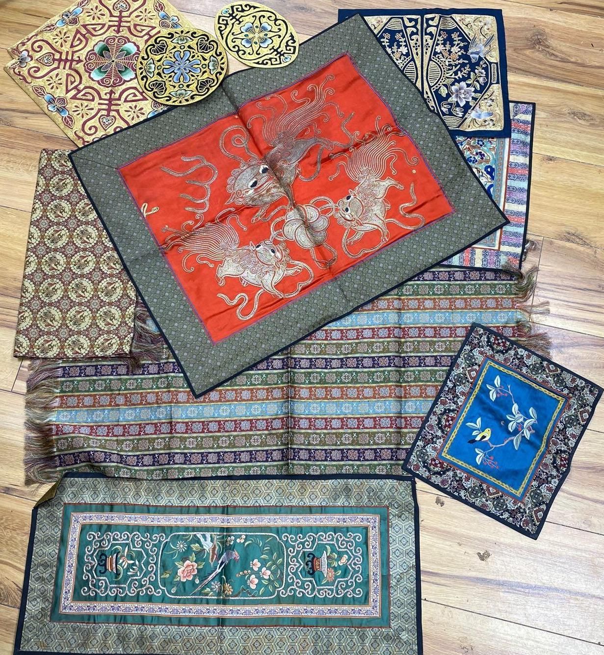 A collection of Chinese embroidered panels, a beaded Portuguese pocket, an Indian mirrored panel and a 19th century